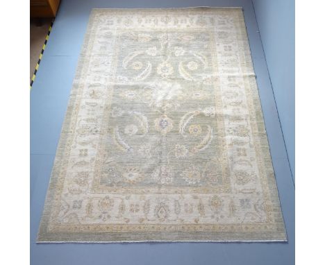A cream-ground Ziglamahal carpet. 277x188cm.Very faded, especially to central lozenge. No fringe. 