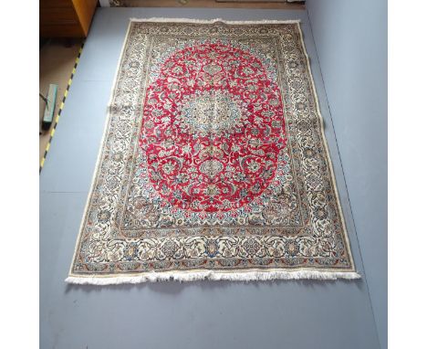 A red and cream-ground Kerman carpet. 270x193cm. 