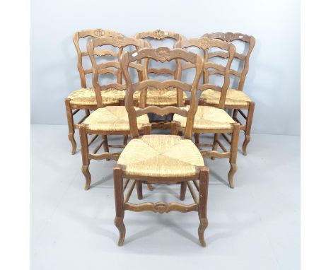 A set of six French oak ladder back dining chairs, with rush seats. 