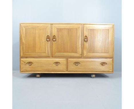 A Mid-Century Ercol Windsor model 468 sideboard, in Golden Dawn with three cupboards and drawers under. 130x76x45cm. 