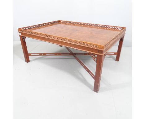 A mahogany Chippendale style mahogany silver table, on cross stretcher, with pierced gallery and decoration. 108x46x77cm. 