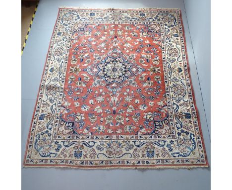 A red and cream-ground Isbahan carpet. 250x196cm. 