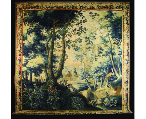 A 17th Century Signed Brussels Tapestry. The woodland landscape  depicting buildings nestled in a central clearing, with a pa