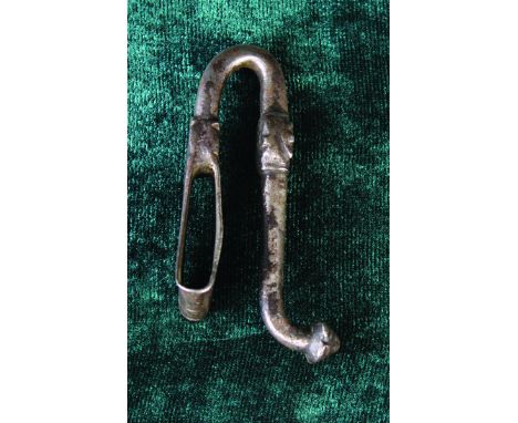 A 16th Century Wrought Iron Belt Hook, possibly French. The belt loop having an upswept hook with ornamental band and protube