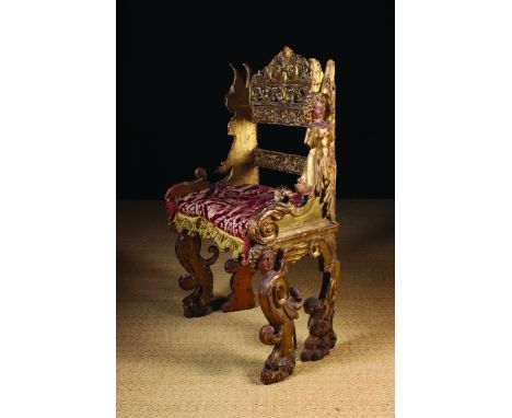 A 17th Century Gilt-wood Chair. The pierced back decorated with undulating scrolls of foliage and having a crested top rail b