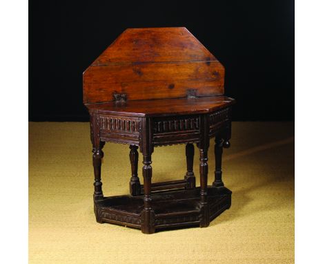 A 17th Century Joined Oak Credence Table. The canted top folding out to form an octagonal, above a gadrooned frieze inlaid wi