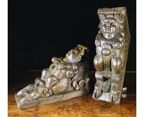 A Pair of Elizabethan Oak Corbels boldly carved with bare-breasted female figures belted with strap-work; each crouched on a 