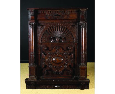 A 17th Century Oak Overmantle in the Laudian Taste decorated with facetted appliqués and strapwork and having an applied cart