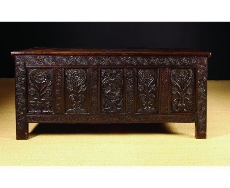 A 17th Century Oak Coffer of Sussex Origin, Circa 1660. The planked top with incised border lines above a five panel facade r