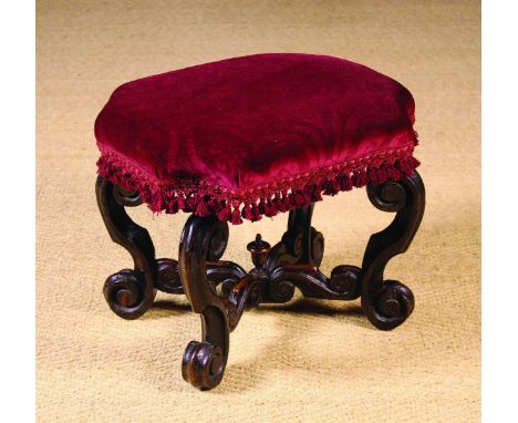 A William & Mary Stool. The padded seat with re-entrant corner quadrants covered in a sculpted crimson velvet edged with tass