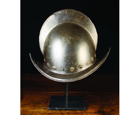 A 16th CenturySpanish Conquistador Morion Helmet; the comb and upswept brim edged in ropetwist, with a band of flower-head st