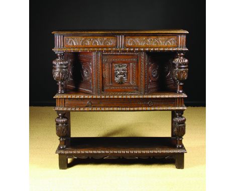 A 17th Century & Later Court Cupboard. The upper section having a lunette carved frieze housing two drawers above a canted cu