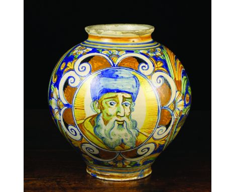 A 17th Century Maiolica Drug Jar. The oviform body decorated in yellow, ochre, green and blue glaze with a portrait roundel t