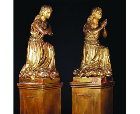 A Pair of 17th Century Carved & Gilded Limewood Female Figures wearing long flowing robes tied at the waist with rope, knelt 