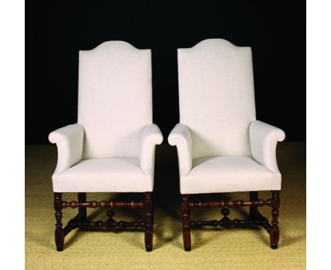 A Pair of Early 18th Century Upholstered Armchairs of modest proportions. The tall arch-topped back, out-swept arms and seats