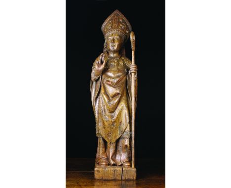 A 16th Century Oak Carving of a Bishop, Northern France, Circa 1500. The figure depicted wearing a miter and cloak holding a 