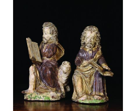 A Pair of 16th/17th Century Polychrome Carvings of Evangelists: The bearded figures with shoulder length curly hair wearing b