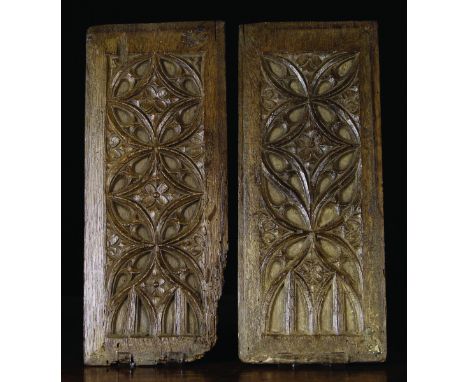 A Pair of 16th Century Oak Panels carved with compass work tracery centred by flowers above double divided arches, 15¾ ins x 