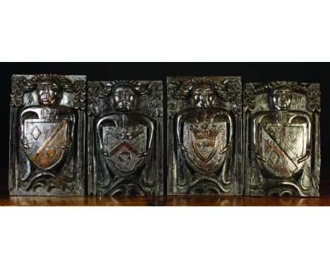 A Set of Four Late 15th Century Oak Panels naively carved in relief with figures bearing heraldic shields enriched with punch