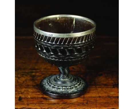A Fine 17th Century Lignum Vitae Goblet enriched with bands of intricate engine turned decoration standing on a short finely 