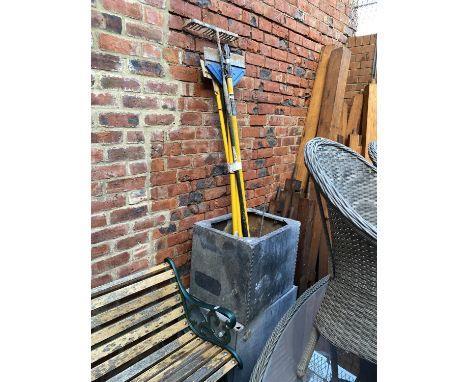 Two galvanised metal water troughs and a bundle of garden tools