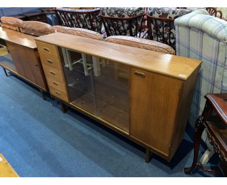 A teak sliding door bookcase, with drawers, 151cm W