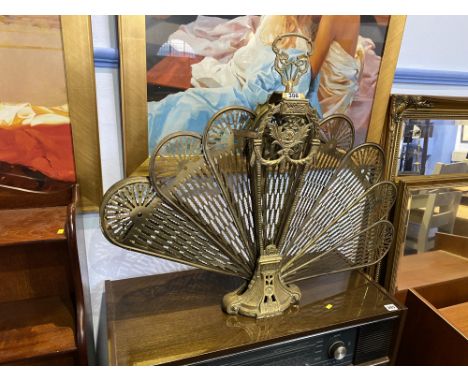 A brass expanding fan fire screen