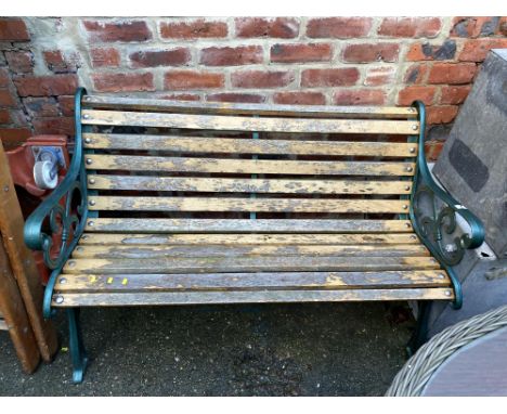 A garden bench with green painted bench ends, 127cm across