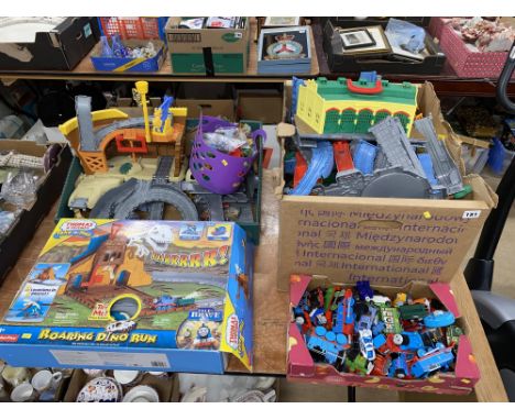 A Thomas and Friends Roaring Dino Run train set, a box of Thomas the Tank Engine trains and two boxes of plastic track and ac