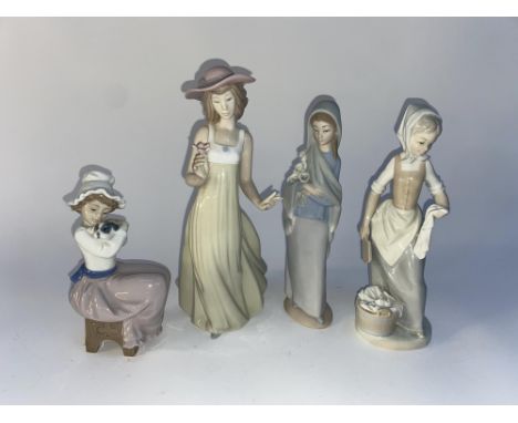 Four Lladro and Nao porcelain figural ornaments, the largest measures 25cm H