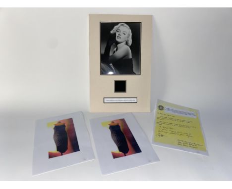 A mounted photographic print of Marilyn Monroe, with material square taken from her black dress, with certificate