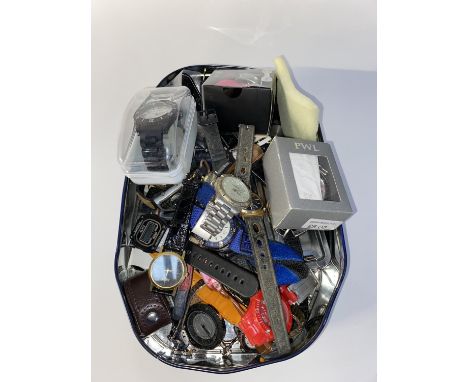 A tin of assorted fashion wrist watches, including digital watches and an Orient crystal watch