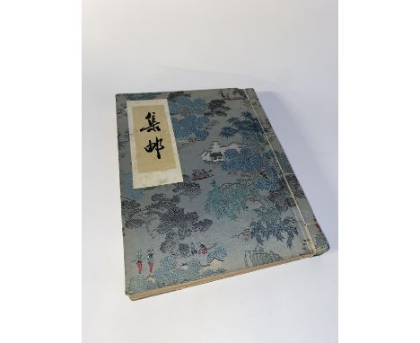 A cloth bound album, containing nine original Indian paintings depicting Ganesha and other subject matter, plus coloured prin