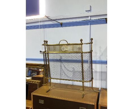 A brass fire screen