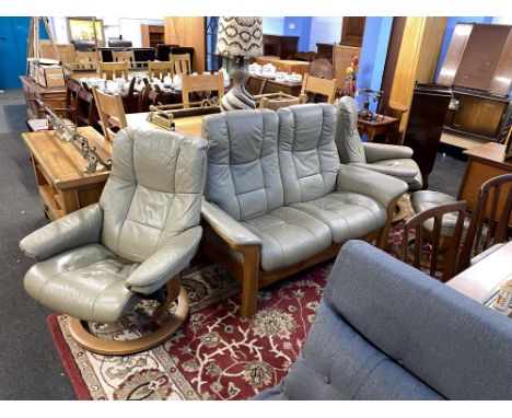 A pair of Stressless reclining chairs and a two seater settee, with foot stool