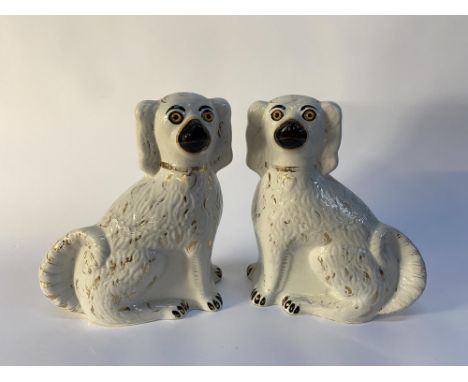 A pair of Victorian Staffordshire flatback spaniels, with glass eyes, each 32cm H