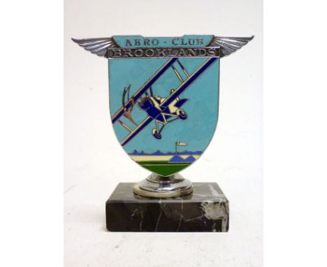 A Brooklands 'Aero-Club' Enamel Car BadgeChrome-plated with 5-colour enamelled design of a vintage bi-plane taking off from t