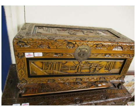SMALL CAMPHOR WOOD CARVED ORIENTAL TRUNK WITH DECORATIVE LOCK RAISED ON SQUAT FEET 