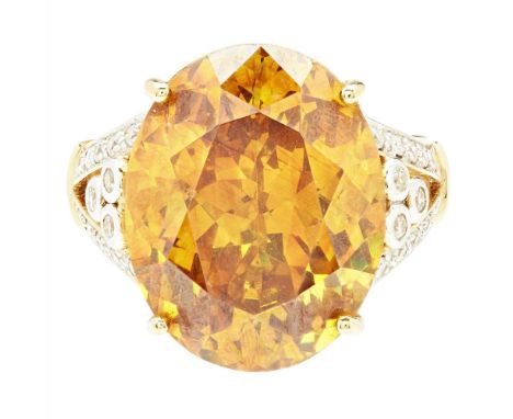 A large topaz and diamond set cocktail ring claw set with a large oval mixed-cut golden-yellow topaz, the split shoulders set