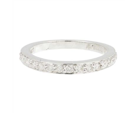 A diamond set half eternity ring claw set with fifteen round brilliant cut diamonds to a plain white metal shank, stamped '14
