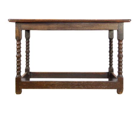 An 18th/19th century oak side table. The rectangular top on ring turned supports joined by stretchers, height 71.5cm, length 