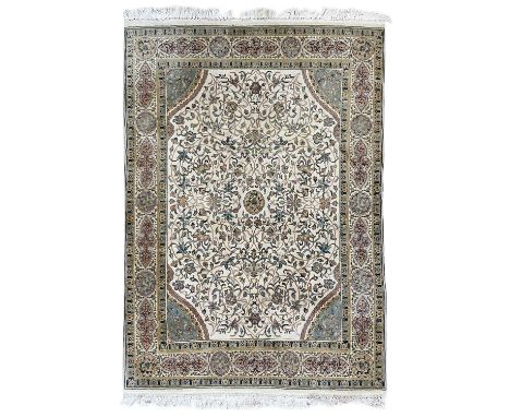 A Persian carpet. The ivory field with large scrolling vines and leaves, 248 x 193cm.