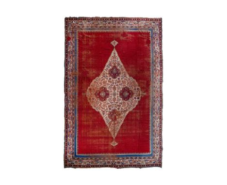 A European carpet, circa 1930. The madder field with a large ivory central medfallion with scrolling flowering leafy vines, w