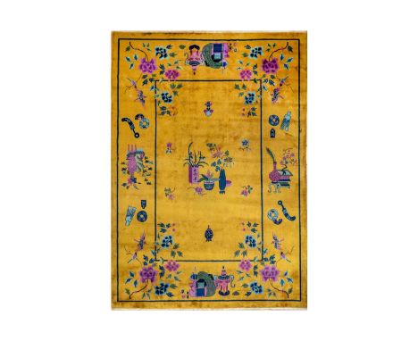 A Chinese 'Deco' carpet, Tianjin, North West China, circa 1930's.   The saffron field decorated with floral sprays and precio