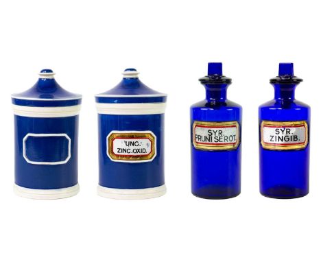 Two blue glass apothecary bottles and stoppers Height 20cm, together with two ceramic apothecary jars and covers.(4)