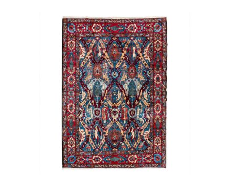 A Tabriz carpet, North West Persia, circa 1930/40's. The blue field with polychrome trellis design and stylised birds, 351 x 