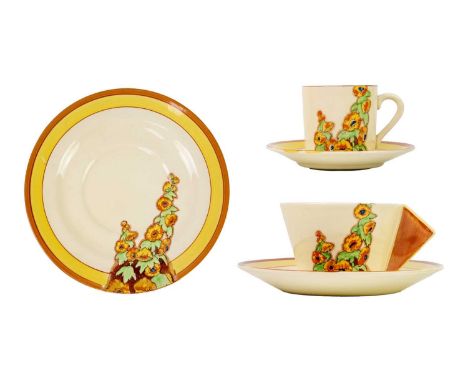 A Clarice Cliff Sunshine pattern conical shape tea cup and saucer. Bizarre Wilkinson Ltd marks, together with another saucer 