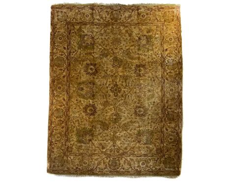 An Indian carpet, mid-late 20th century. With a central polychrome medallion, large palmettes, flowering vines and leaves, wi