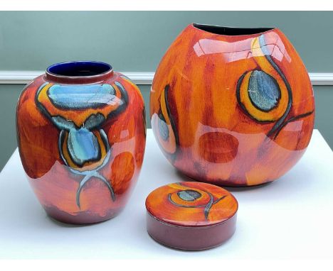 MODERN POOLE ORANGE GROUND 'PEACOCK' DESIGN POTTERY , to include purse vase, 26cms high, together with a lidded pot, and a ov