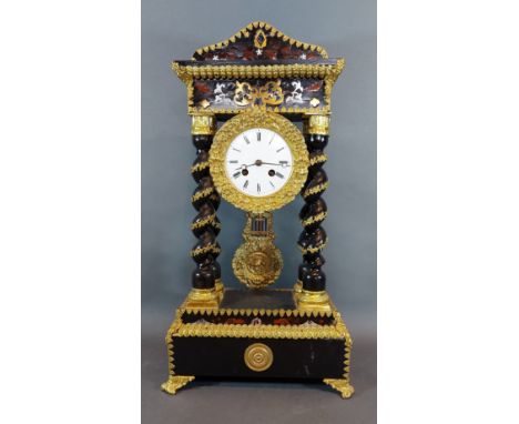 A 19th Century French ebonised and brass mounted Portico clock, the circular enamel dial with Roman numerals and two train mo